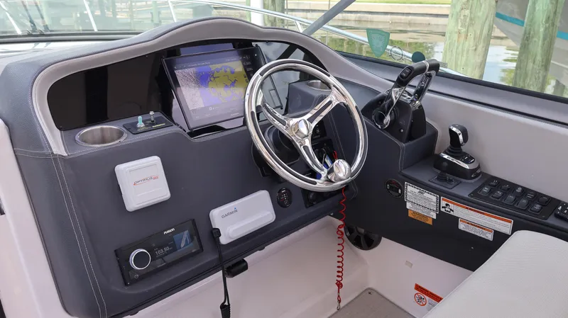 Slide: The Image of Helm of 2021 Regal 33 XO boat with modern controls and navigation system. - 42