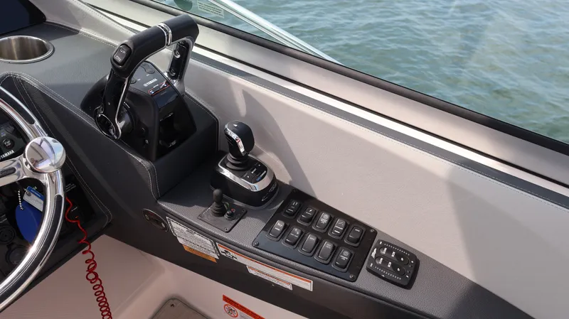 Slide: The Image of Control panel of a 2021 Regal 33 XO boat with throttle and joystick. - 43