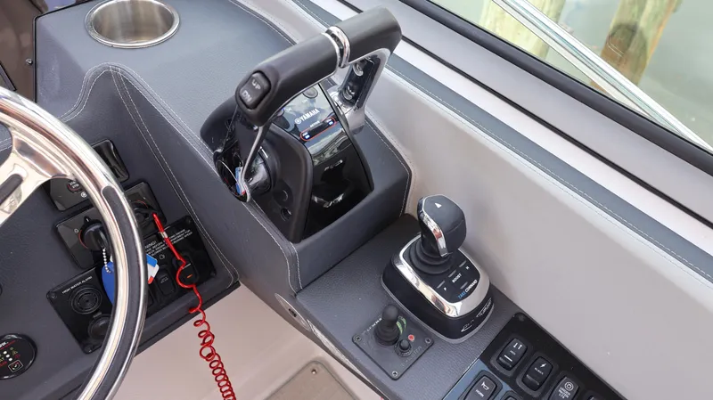 Slide: The Image of Control panel of 2021 Regal 33 XO boat with steering wheel and throttle. - 44