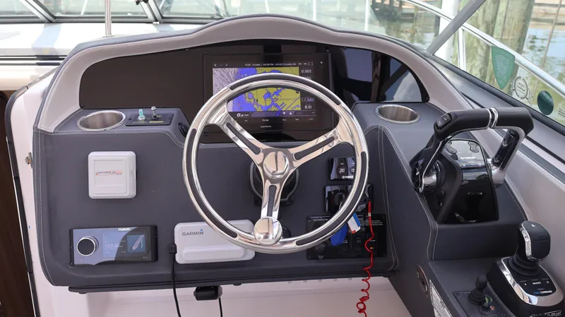 Slide: The Image of Helm of 2021 Regal 33 XO boat with navigation controls and steering wheel. - 45