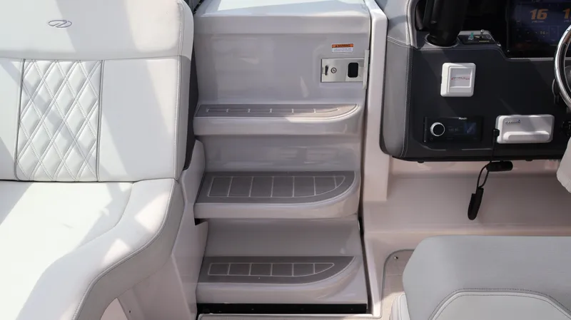 Slide: The Image of 2021 Regal 33 XO boat interior with steps and seating, featuring modern design and controls. - 46