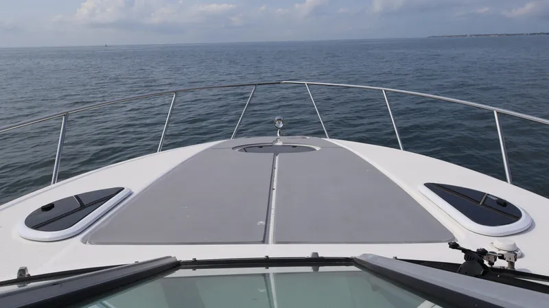 Slide: The Image of 2021 Regal 33 XO boat deck view on open water. - 49