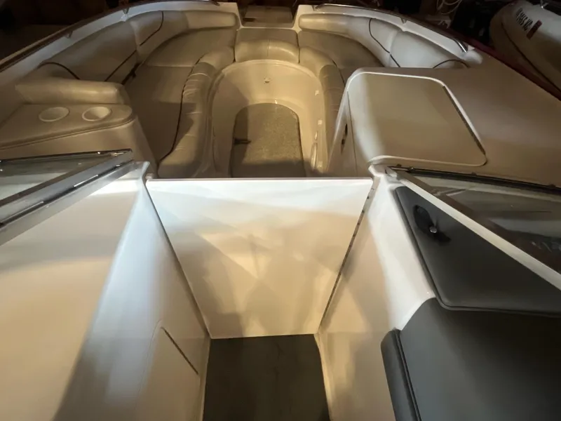 Slide: The Image of 2002 Ebbtide 2400 Mystique boat interior with spacious seating and sleek design. - 11