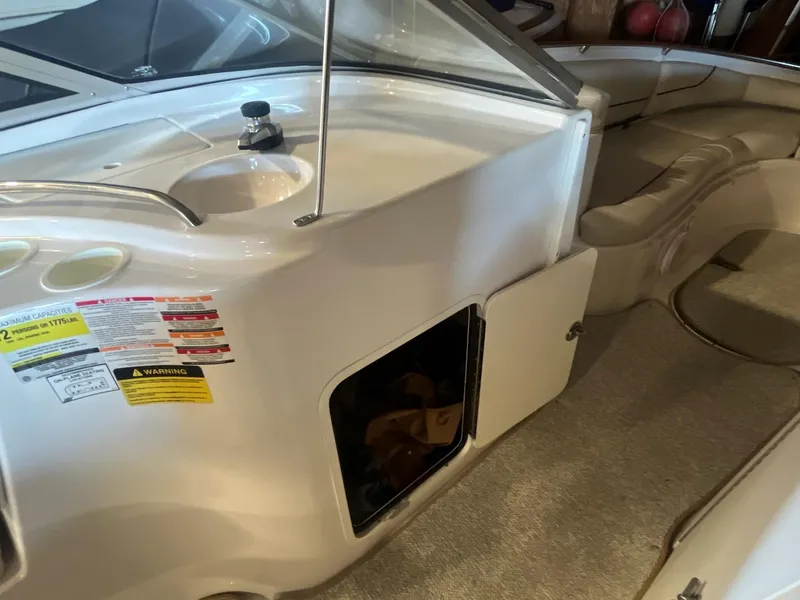 Slide: The Image of 2002 Ebbtide 2400 Mystique boat interior with seating and storage compartment. - 12