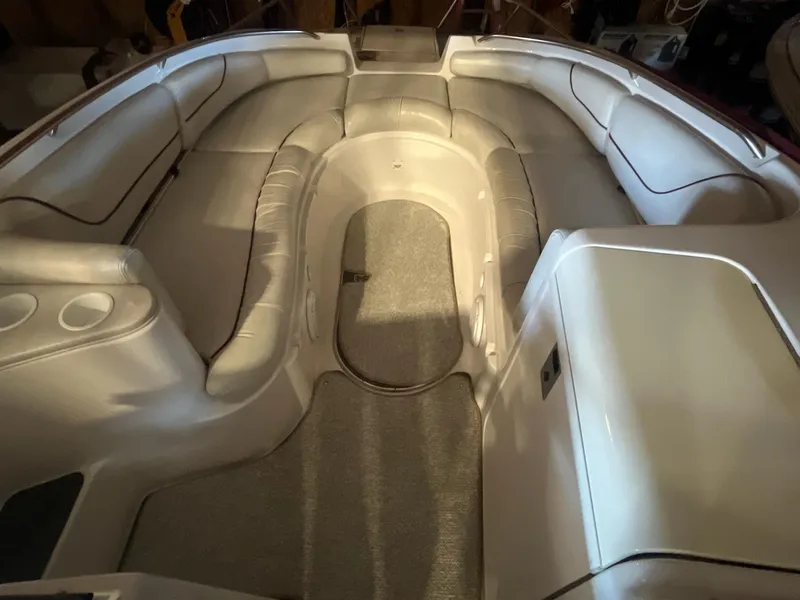 Slide: The Image of 2002 Ebbtide 2400 Mystique boat interior with spacious seating and cup holders. - 13
