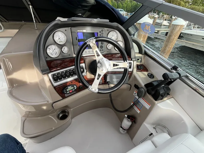 Slide: The Image of 2002 Ebbtide 2400 Mystique boat dashboard with steering wheel and control panel. - 14