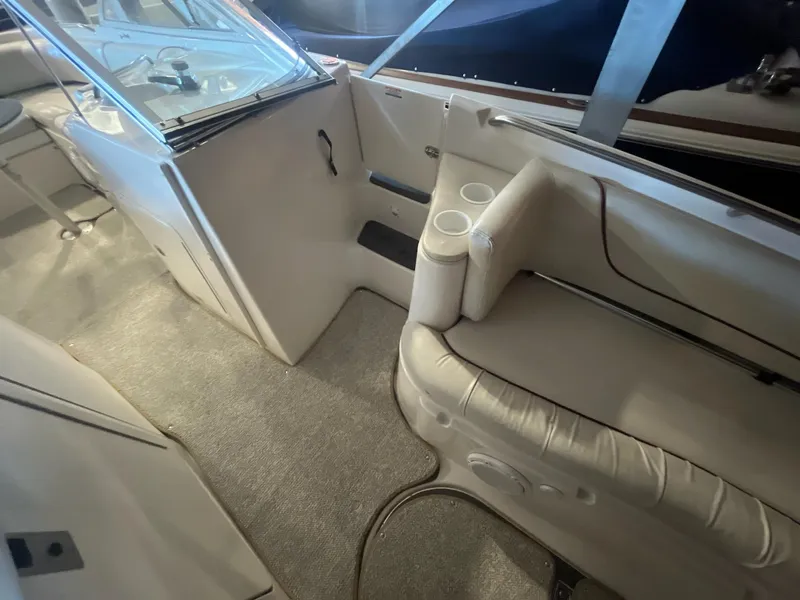 Slide: The Image of 2002 Ebbtide 2400 Mystique boat interior with seating and cup holders. - 17