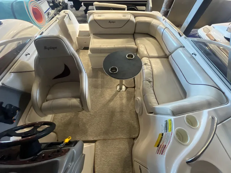 Slide: The Image of 2002 Ebbtide 2400 Mystique boat interior with seating and table. - 18