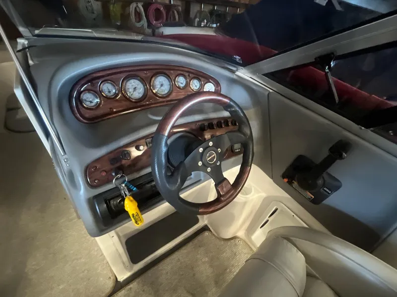 Slide: The Image of 2002 Ebbtide 2400 Mystique boat dashboard with steering wheel and instrument panel. - 9