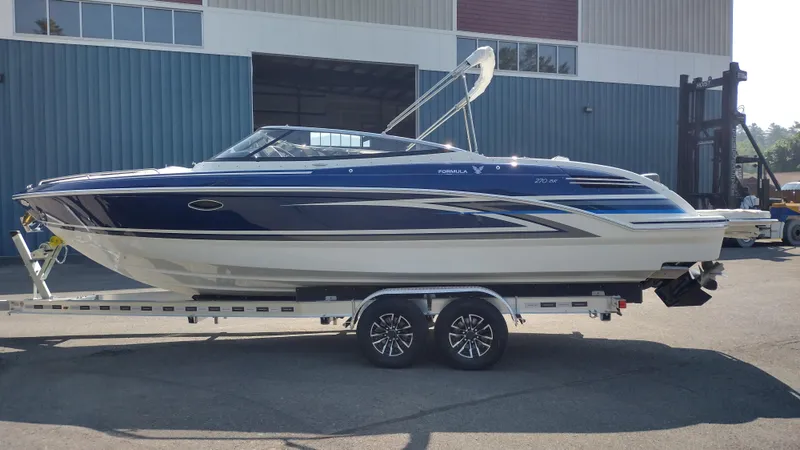 Slide: The Image of 2026 Formula 270 Bowrider boat on trailer, parked outdoors. - 1