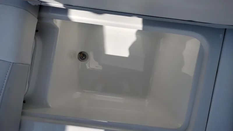 Slide: The Image of 2026 Formula 270 Bowrider under-seat storage compartment with open lid. - 32