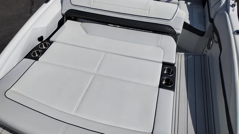 Slide: The Image of 2026 Formula 270 Bowrider interior with white and black seating, cup holders, and speaker. - 47