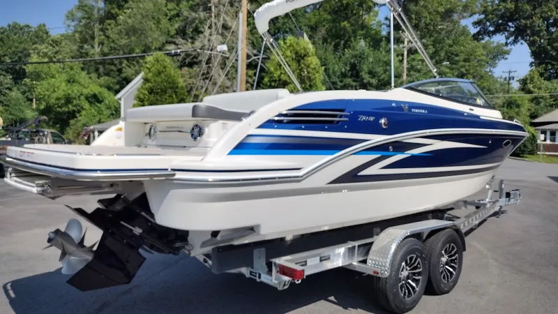 Slide: The Image of 2026 Formula 270 Bowrider boat on trailer, sleek design, blue and white exterior. - 5
