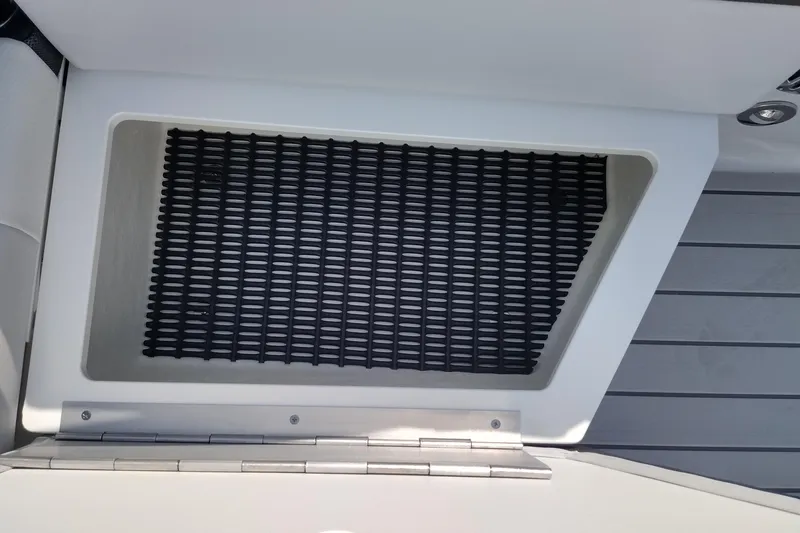 Slide: The Image of Storage compartment in a 2026 Formula 270 Bowrider boat with a blue bag inside. - 59