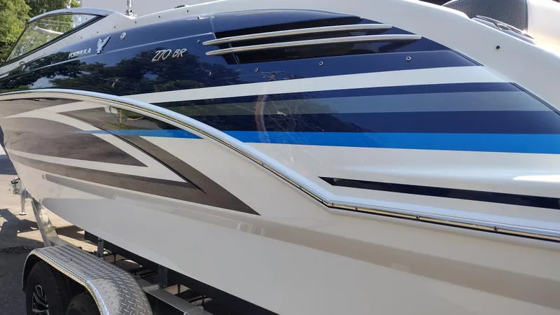 Slide: The Image of 2026 Formula 270 Bowrider boat with sleek design and modern graphics. - 8