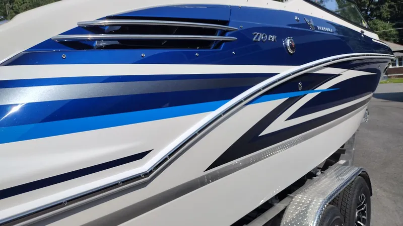 Slide: The Image of Rear view of 2026 Formula 270 Bowrider boat on pavement, clear sky background. - 9