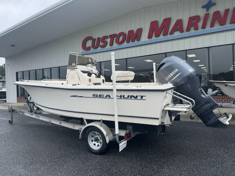 Slide: The Image of 2003 Sea Hunt 202 TRITON boat on trailer at Custom Marine dealership. - 1