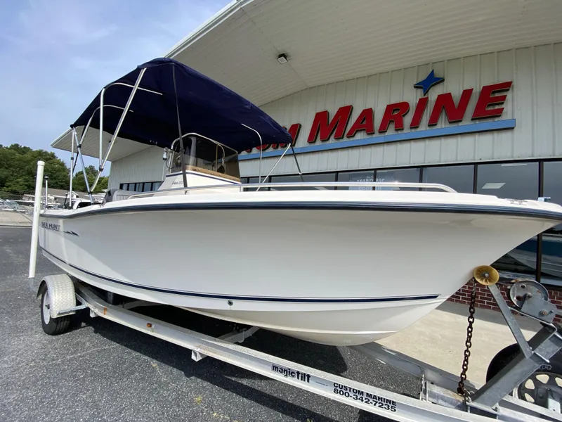 Slide: The Image of 2003 Sea Hunt 202 TRITON boat on trailer outside marine dealership. - 15