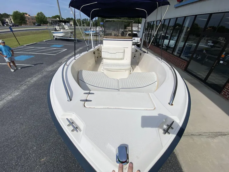 Slide: The Image of 2003 Sea Hunt 202 TRITON boat with spacious deck and seating, parked outdoors. - 16