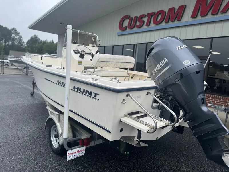 Slide: The Image of 2003 Sea Hunt 202 TRITON boat with Yamaha 150 engine on trailer, parked outside dealership. - 2
