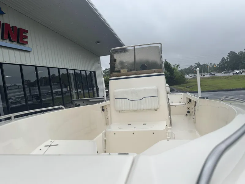 Slide: The Image of 2003 Sea Hunt 202 TRITON boat, white interior, parked near a building on a cloudy day. - 8