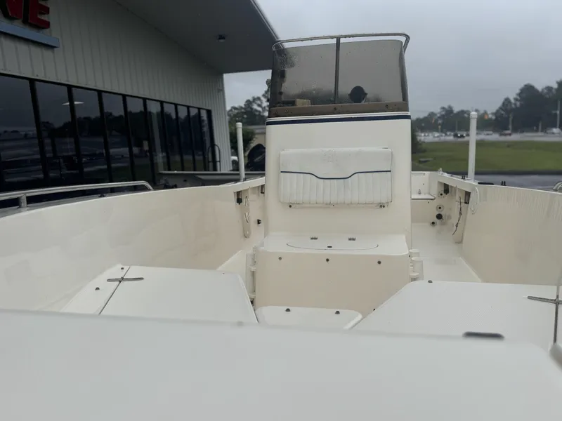 Slide: The Image of 2003 Sea Hunt 202 TRITON boat interior with console and seating, displayed outdoors. - 9