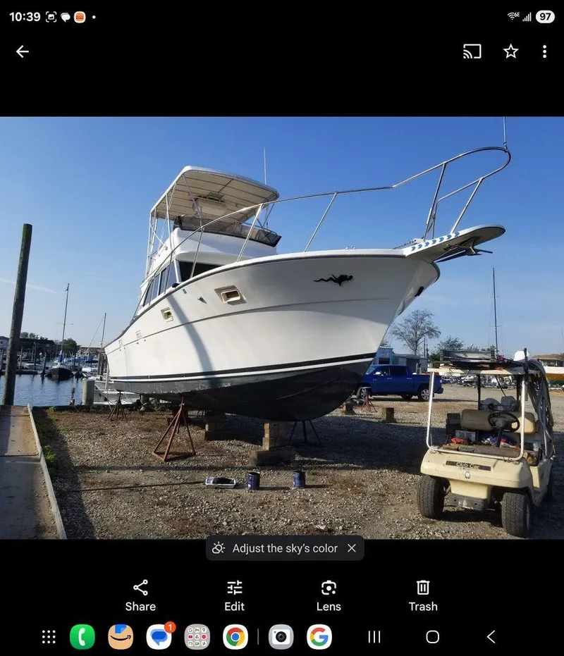 Slide: The Image of 1979 Viking yacht on dry dock, marina background, clear sky. - 0