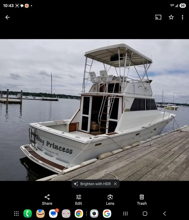Slide: The Image of 1979 Viking Yacht docked at marina, named "Viking Princess," with overcast sky. - 1