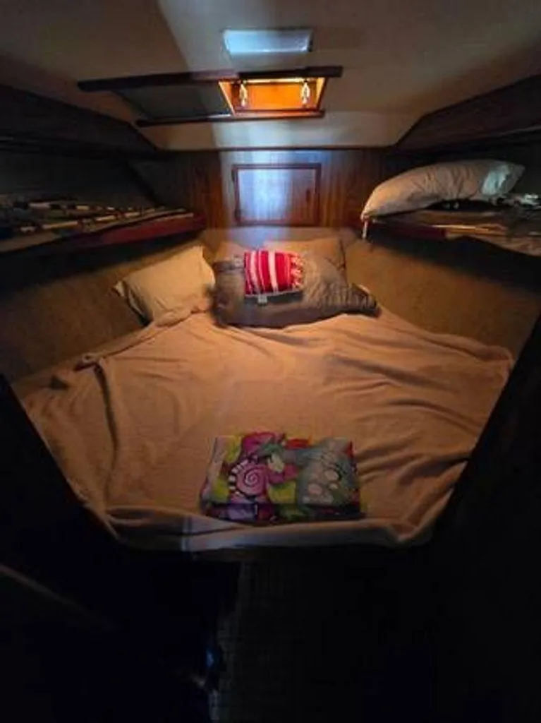 Slide: The Image of Cozy cabin interior of a 1979 Viking yacht with a neatly made bed. - 11