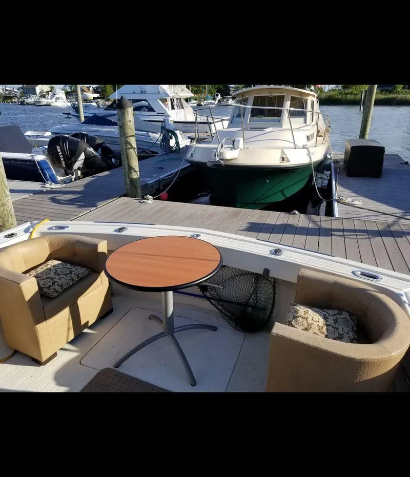Slide: The Image of 1979 Viking Yacht with cozy seating and table, docked at a marina. - 13