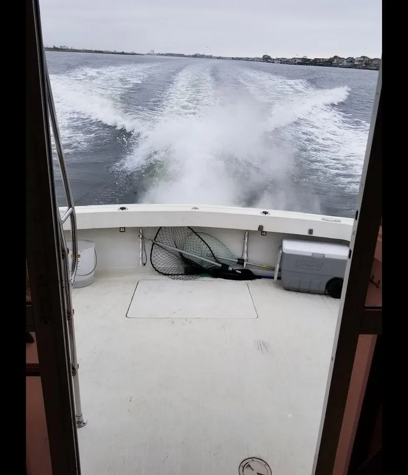 Slide: The Image of 1979 Viking Yacht cruising, view from deck with fishing gear and cooler. - 14