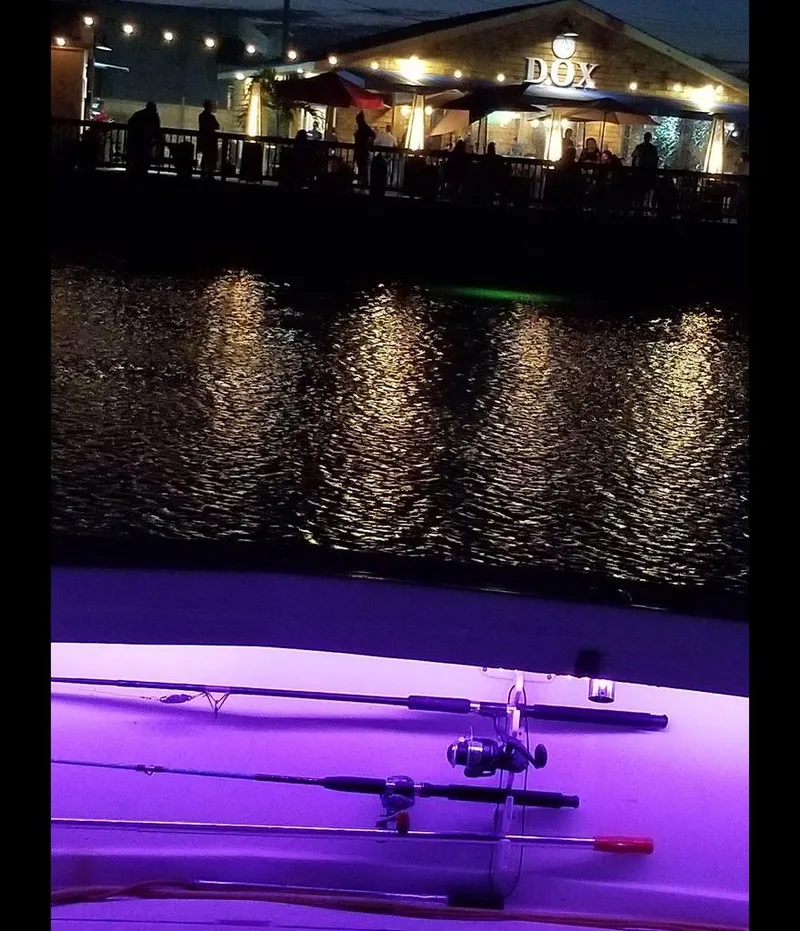 Slide: The Image of 1979 Viking Yacht with fishing rods, night view of waterfront restaurant. - 15