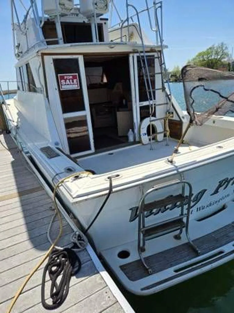 Slide: The Image of 1979 Viking yacht for sale, docked with open cabin and visible ladder. - 2
