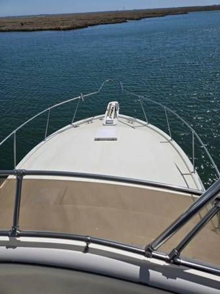 Slide: The Image of 1979 Viking Yacht cruising on calm waters, view from the bow. - 4