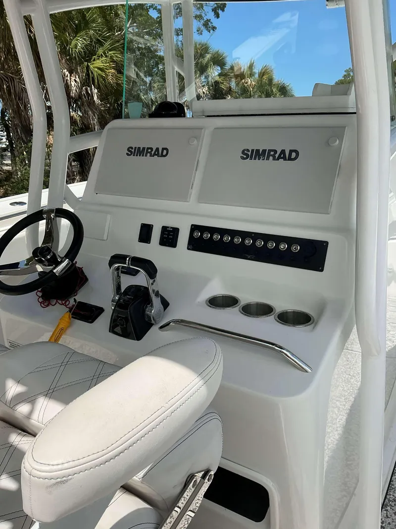 Slide: The Image of 2017 Cape Horn 36 XS boat console with Simrad displays and steering wheel. - 10