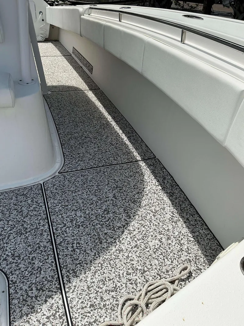 Slide: The Image of 2017 Cape Horn 36 XS boat interior with speckled flooring and white seating. - 12