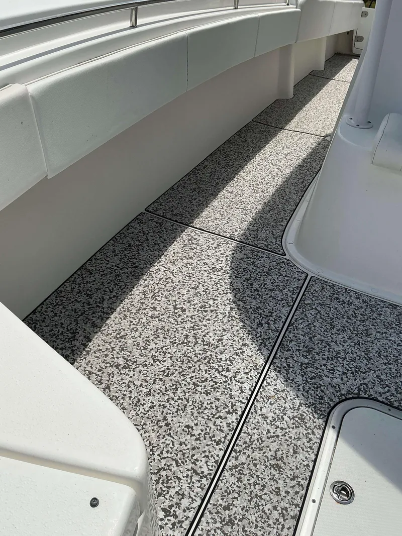 Slide: The Image of 2017 Cape Horn 36 XS boat deck with speckled flooring and white seating. - 24