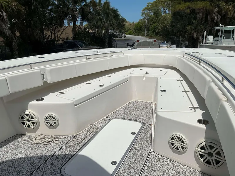 Slide: The Image of 2017 Cape Horn 36 XS boat interior with seating and speakers, surrounded by lush greenery. - 9