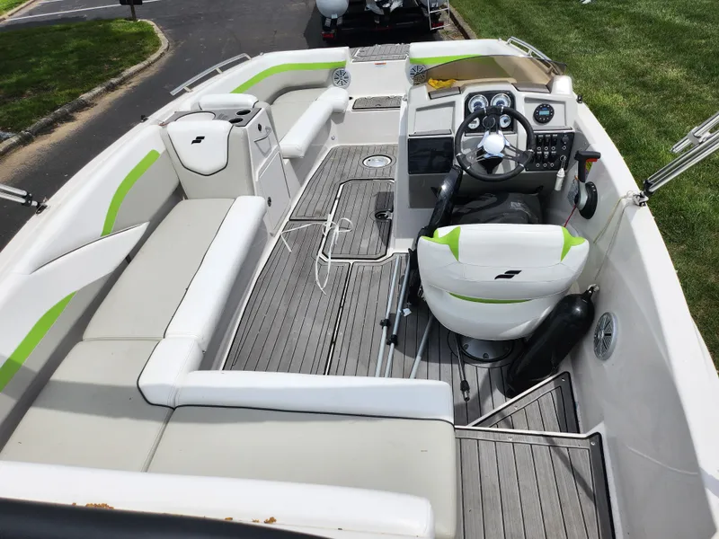 Slide: The Image of 2023 Starcraft SVX 191 OB boat interior with white and green seating, modern dashboard, and spacious layout. - 10