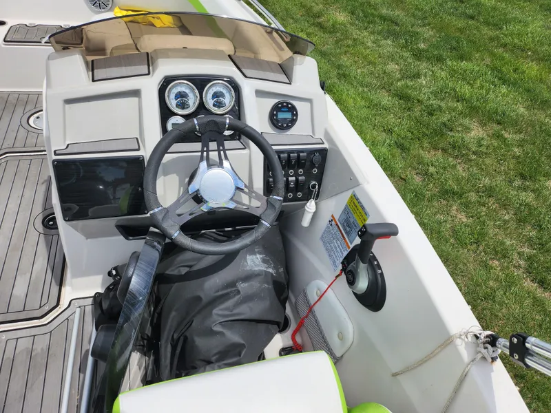 Slide: The Image of 2023 Starcraft SVX 191 OB boat dashboard with steering wheel and controls. - 11