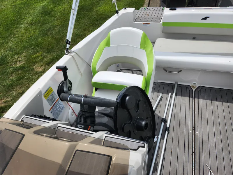 Slide: The Image of 2023 Starcraft SVX 191 OB boat interior with green and white seating and steering wheel. - 18
