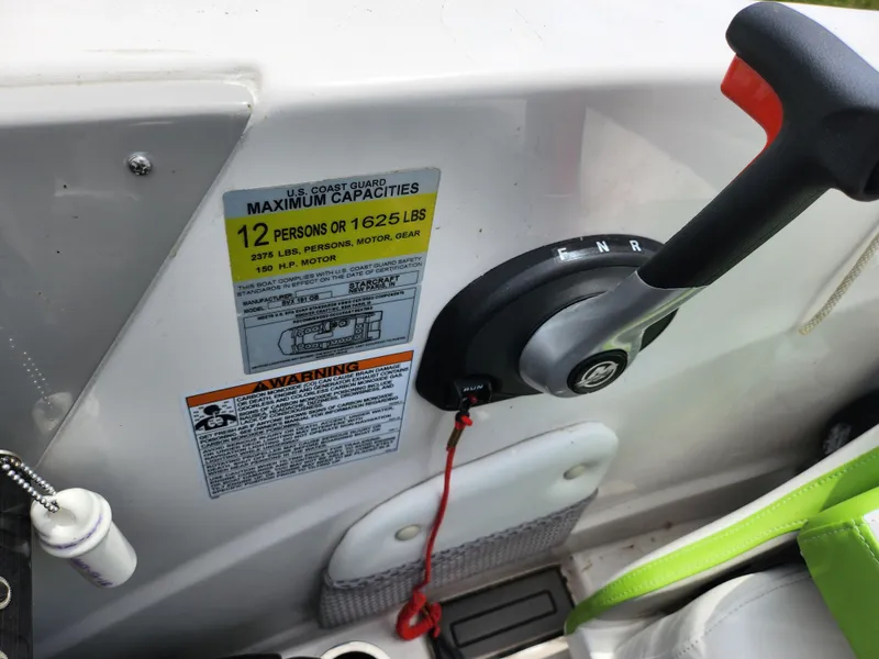 Slide: The Image of 2023 Starcraft SVX 191 OB boat control panel with capacity warning label. - 20