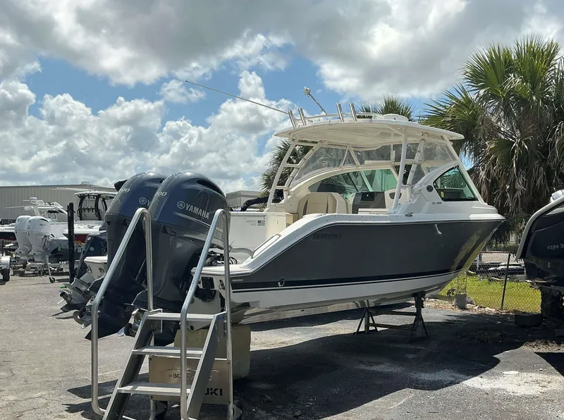 Slide: The Image of 2020 Pursuit DC 266 boat with twin Yamaha engines on display outdoors. - 1