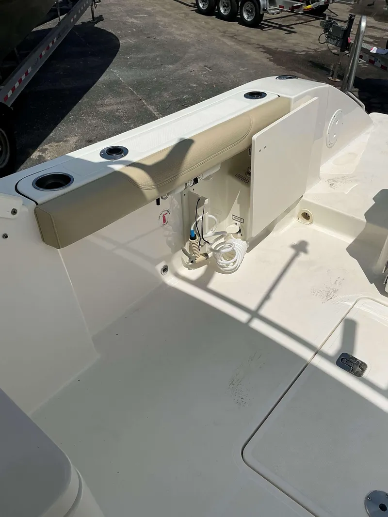 Slide: The Image of 2020 Pursuit DC 266 boat interior with seating and storage compartment. - 4