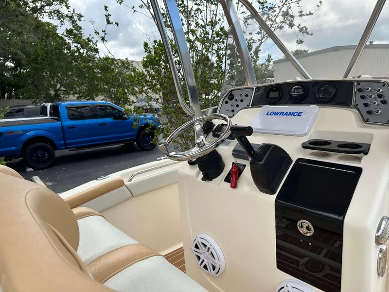 Slide: The Image of 2014 Scout 215 XSF boat dashboard with steering wheel and Lowrance equipment. - 7
