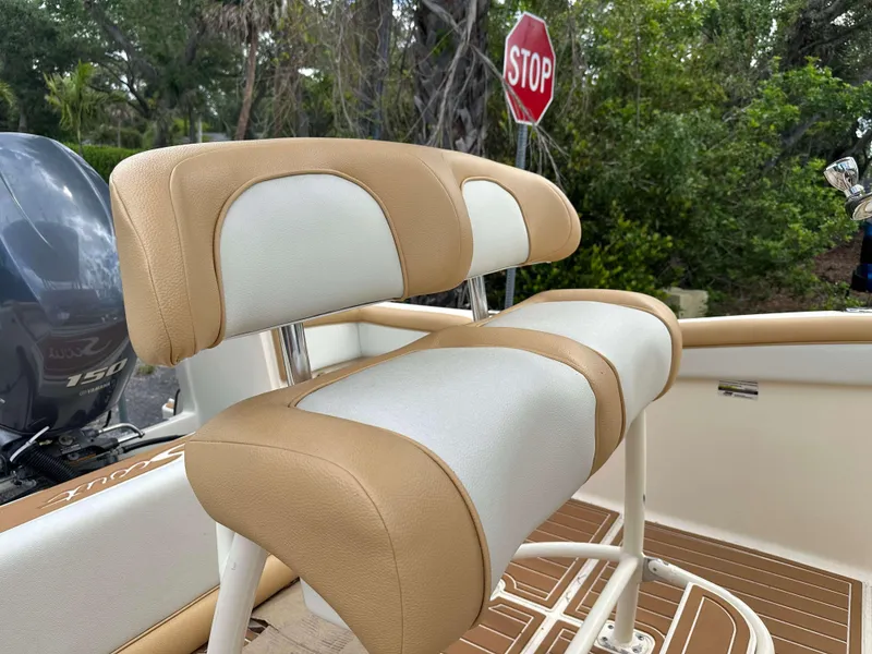 Slide: The Image of 2014 Scout 215 XSF boat interior with tan and white seating, Yamaha 150 engine visible. - 8
