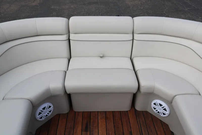 Slide: The Image of 2015 Bennington 22SSLDX boat interior with beige seating and wooden flooring. - 14