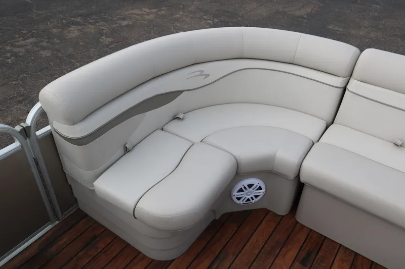 Slide: The Image of 2015 Bennington 22SSLDX pontoon boat interior with beige seating and wood flooring. - 18