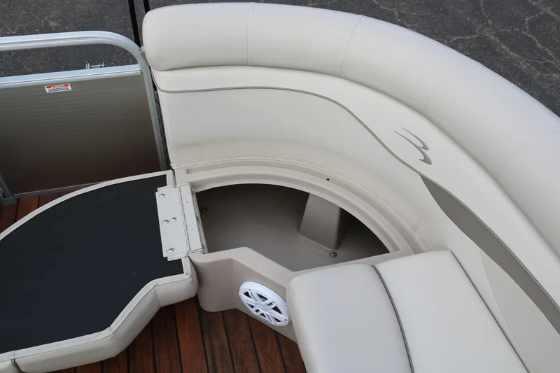 Slide: The Image of 2015 Bennington 22SSLDX pontoon boat interior with beige seating and wood flooring. - 19