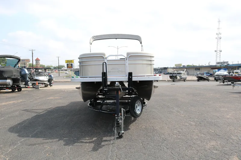 Slide: The Image of 2015 Bennington 22SSLDX pontoon boat on trailer in parking lot. - 2